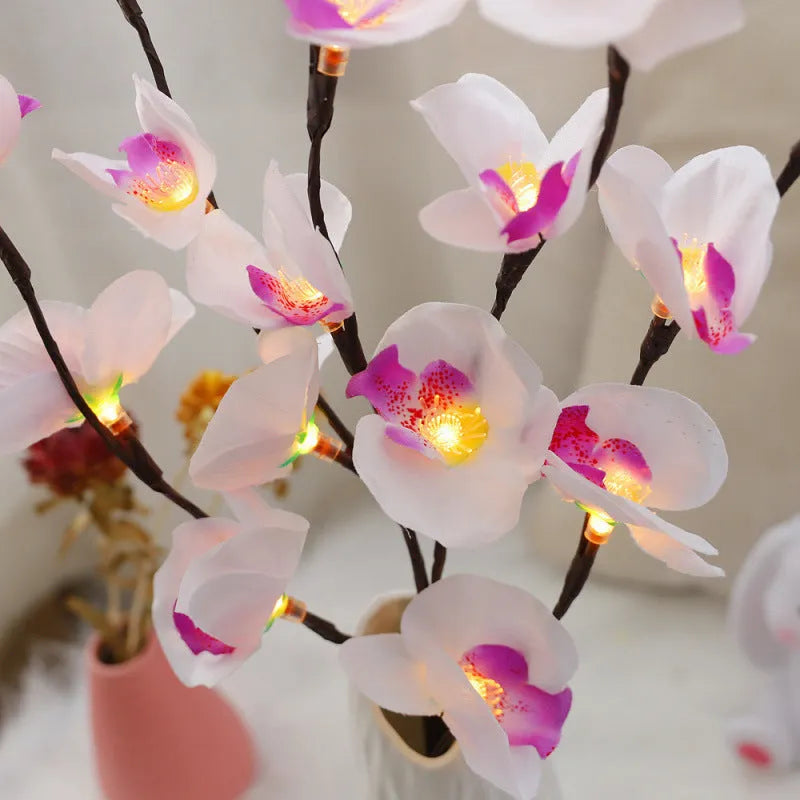 Pink Phalaenopsis branch shaped decorative LED light with 20 warm white lights, powered by batteries.