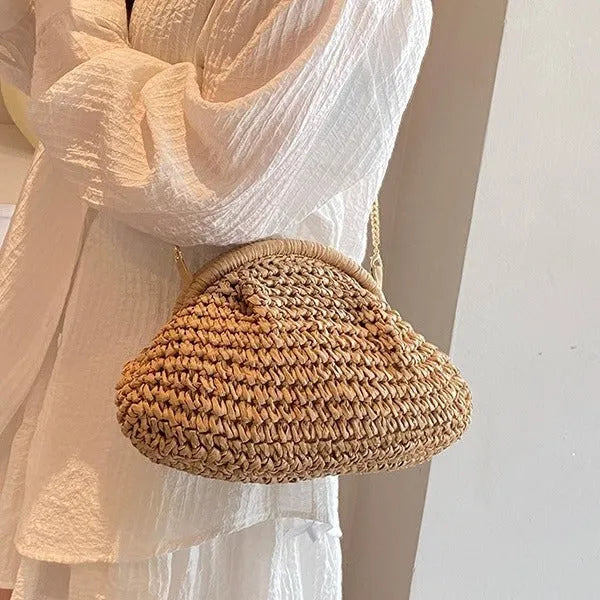 Women's beige straw shoulder bag with chain detail and a zippered interior.