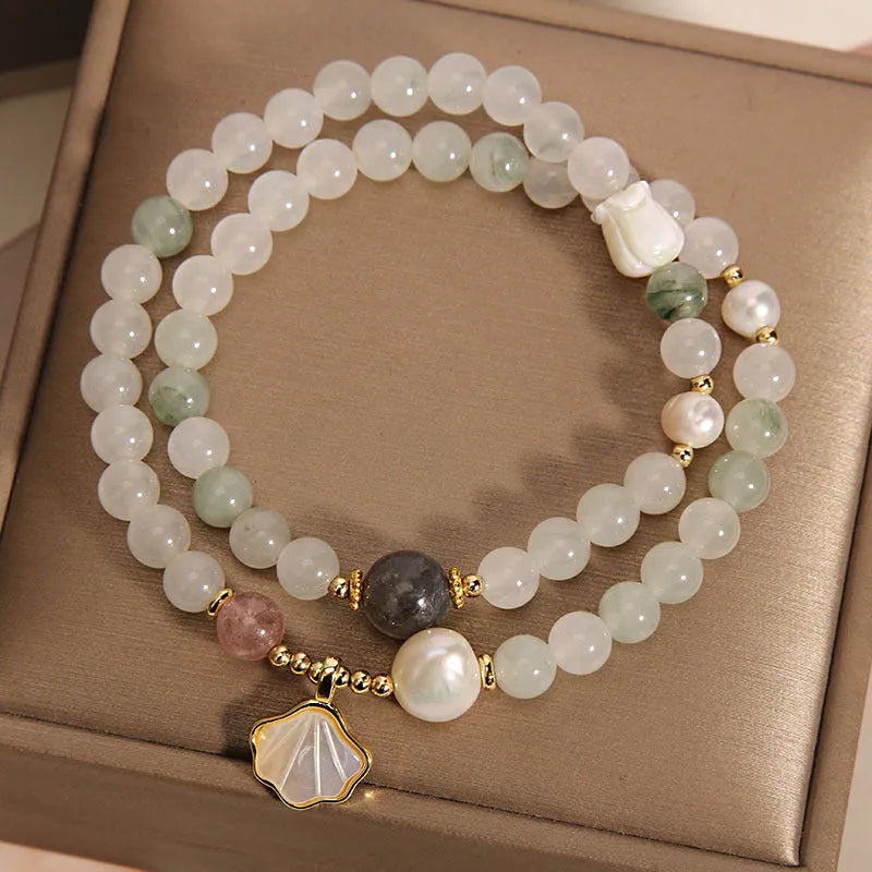 Women's crystal bracelet with green ginkgo leaf pendant, gold accents and rhinestones