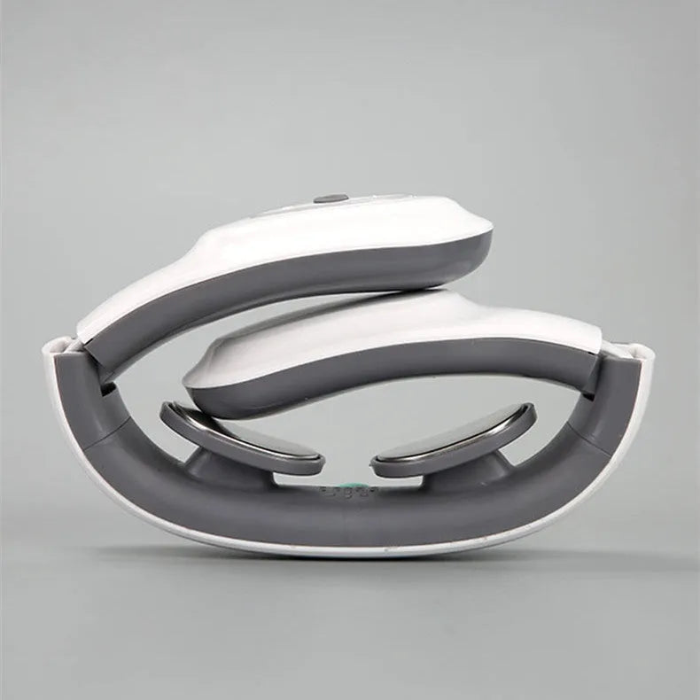 White electric pulse shoulder and neck massager with hot compress, folded compactly on a table