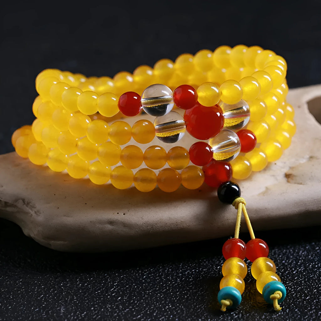 Polished crystal canary stone 108-bead geometric necklace with Lucky Cat detail on white background