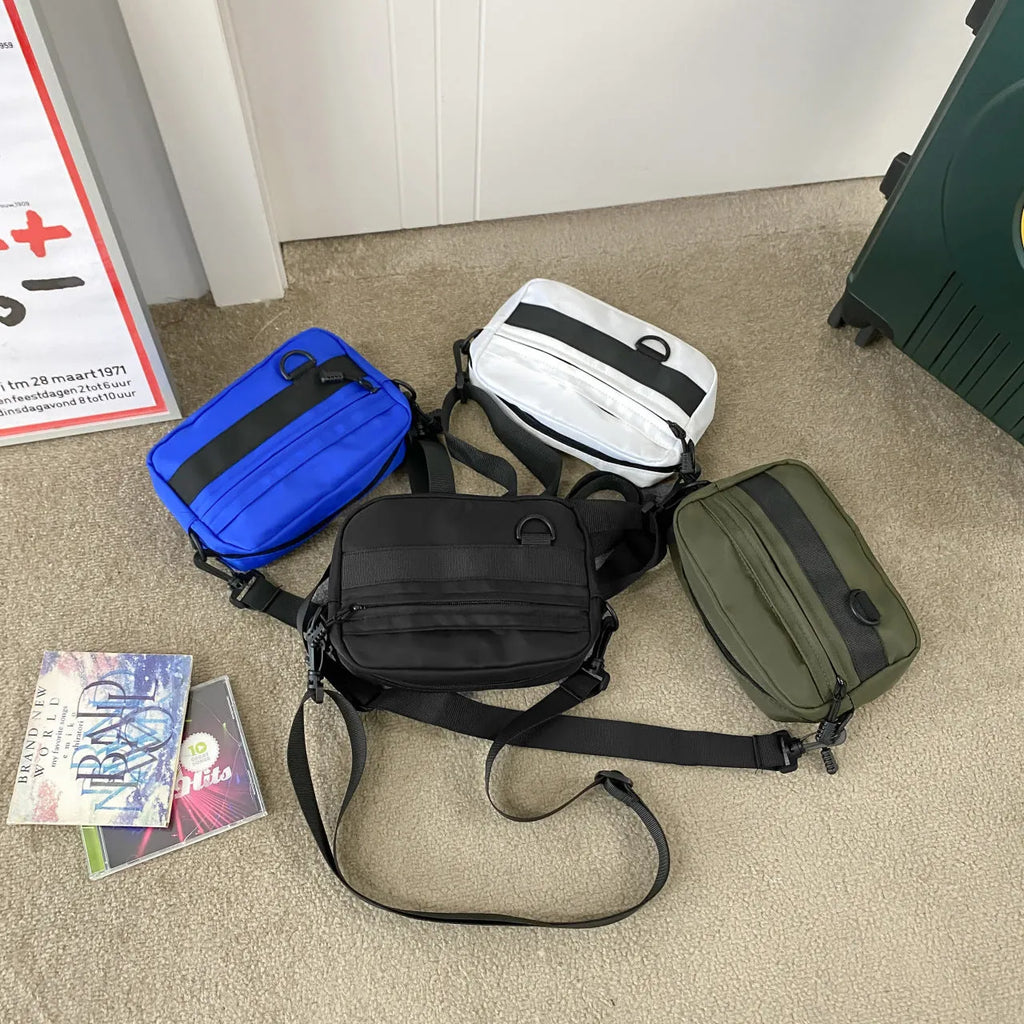Men's solid colour polyester and nylon crossbody messenger bag shown in black, blue, green, or white.