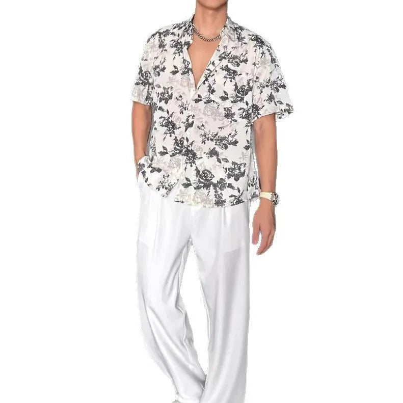 Loose fit black floral print short sleeve casual shirt on a hanger