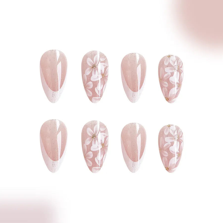 Short almond false nails with French manicure style and glittering floral powder accents in C625 colour