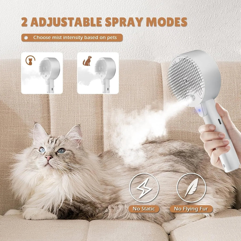 Pink cat steam brush for shedding with rounded massage head and transparent water tank on white background