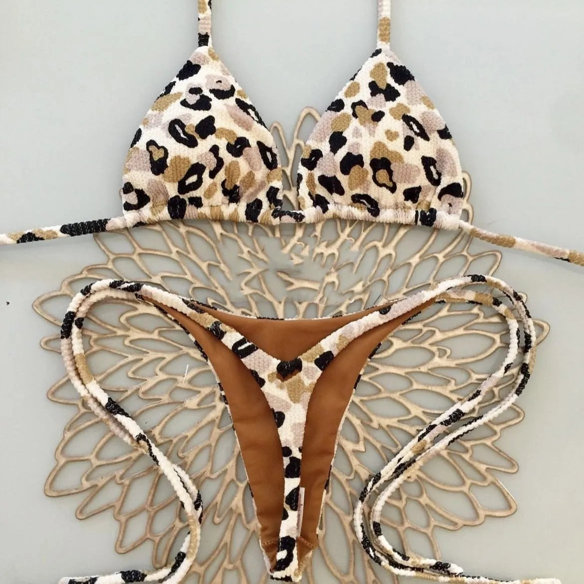 Women's printed bikini swimsuit set with quick-dry fabric on a mannequin, showing briefs style.