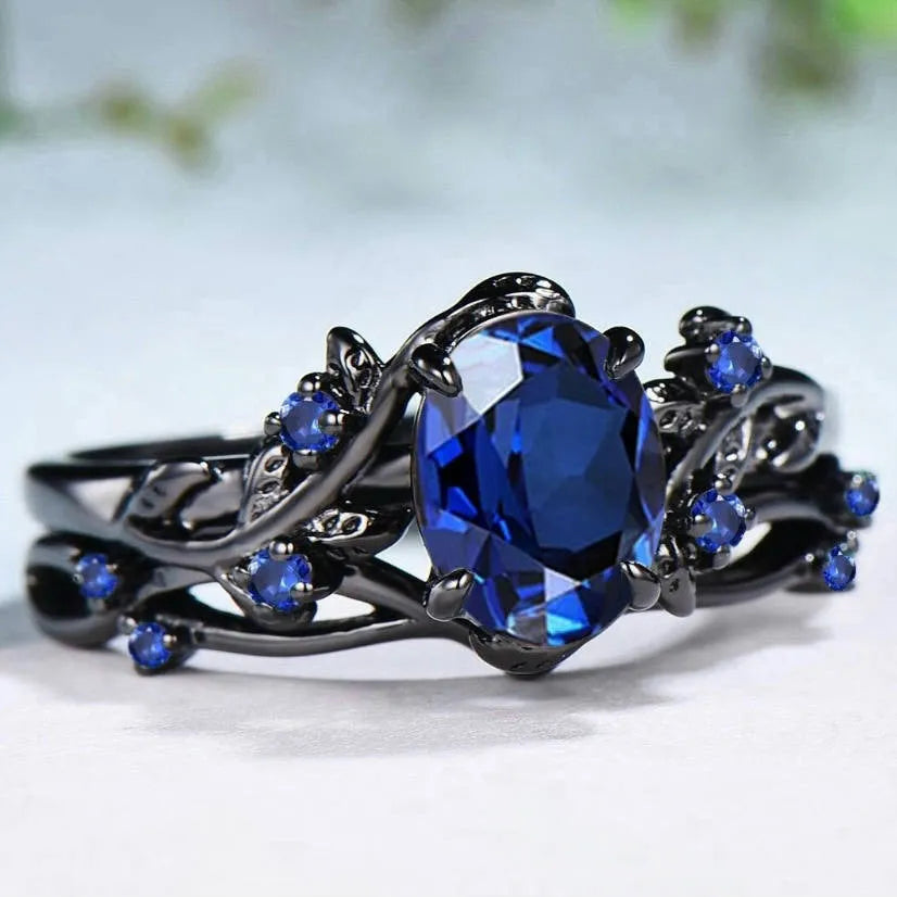 Black gun finish women's ring with navy blue rhinestone inlay on copper geometric band