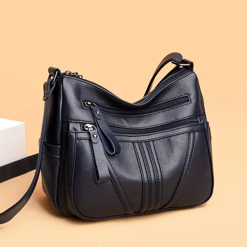 Genuine leather horizontal square messenger bag with contrasting stitching and single shoulder strap in black