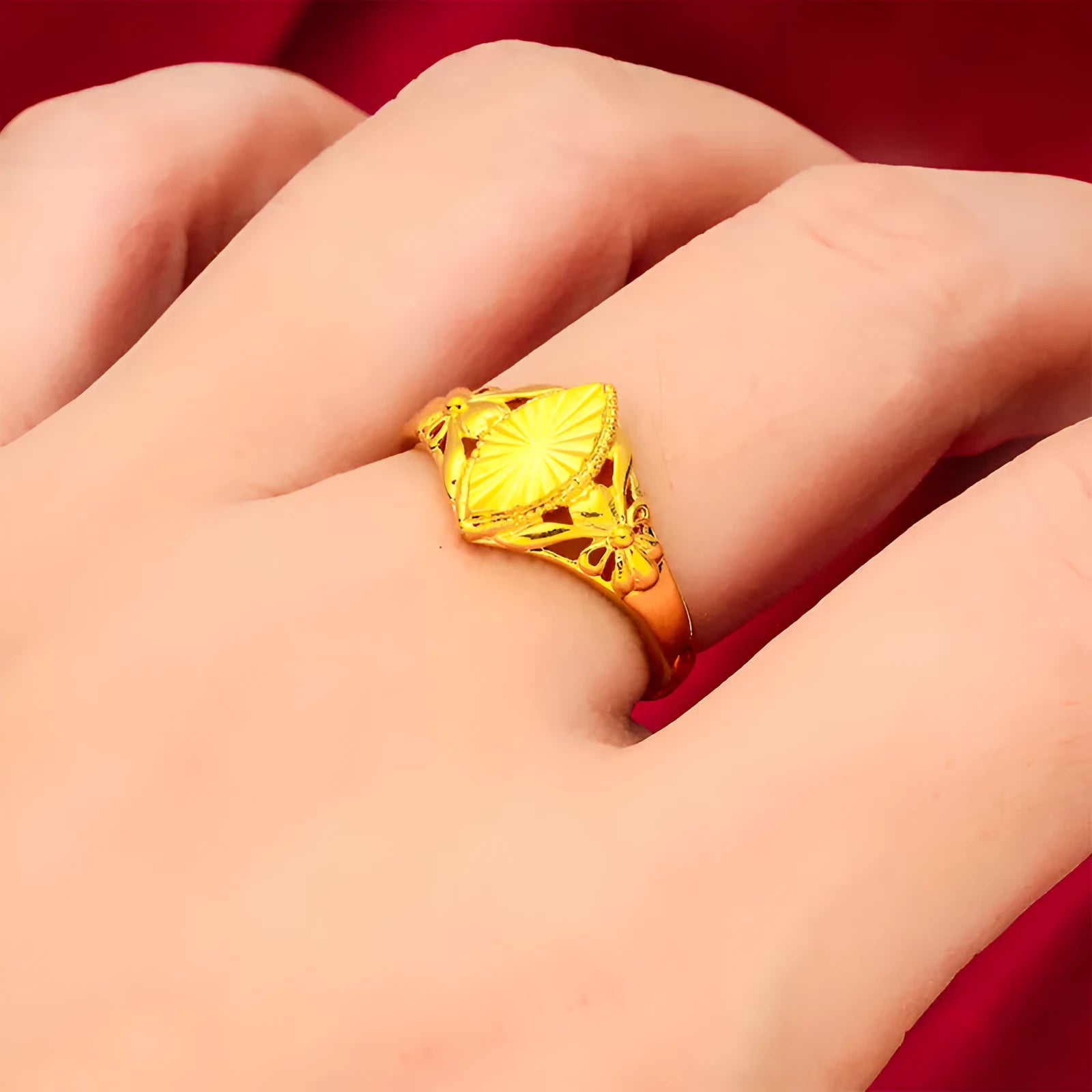 Gold coloured open diamond flower shape ring with geometric textured details on a brass base.