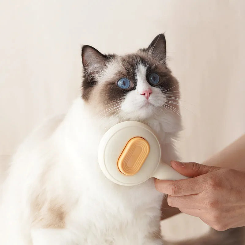 Green and yellow handled stainless steel pet grooming brush for cats and dogs on a white background.