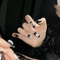 Black and pink heart hand-painted artificial nail set with cat's eye design in four sizes