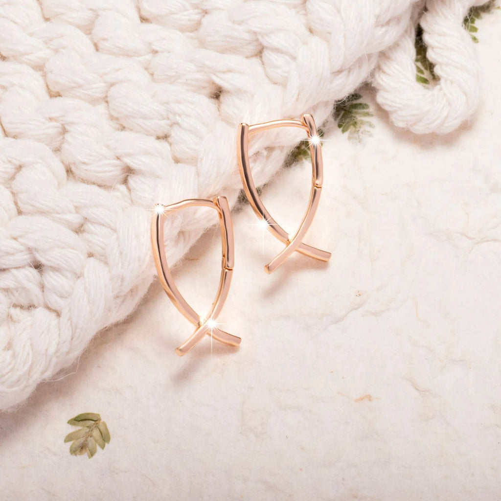 Rose gold plated copper cross earrings with symmetrical design and post fittings