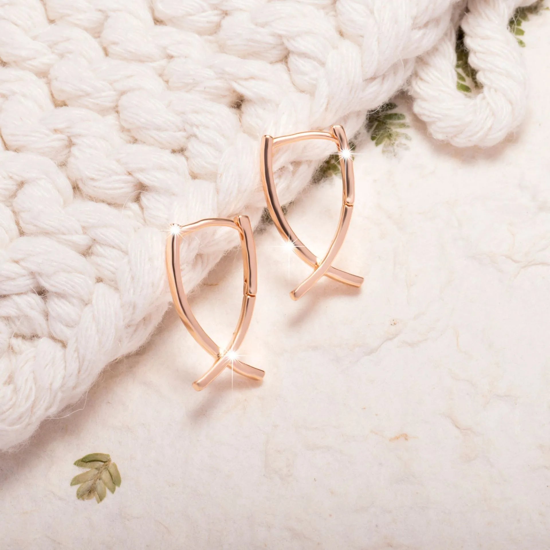 Rose gold plated copper cross earrings with symmetrical design and post fittings