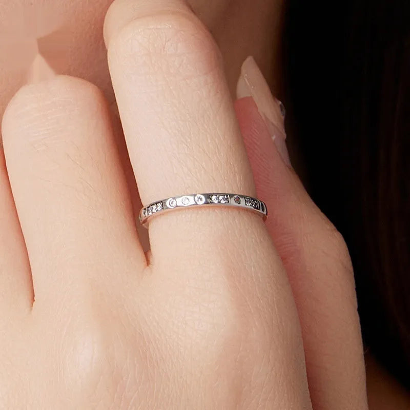 SCR1157 Moss Password I Love You oxidised black silver ring on a hand, showing simple bracelet style.