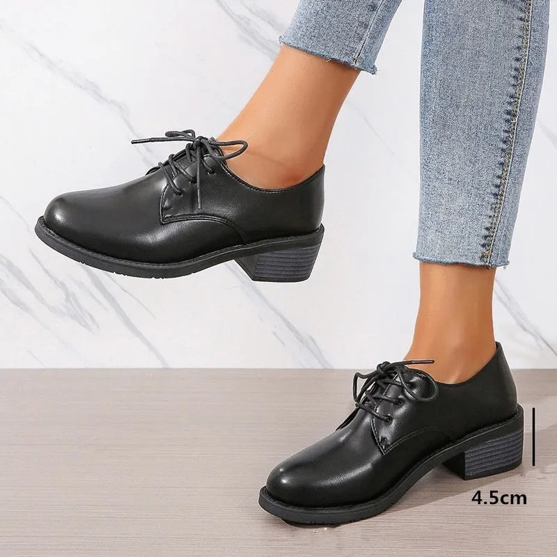 Black women's low-top shoes with a chunky mid-height heel and round toe.