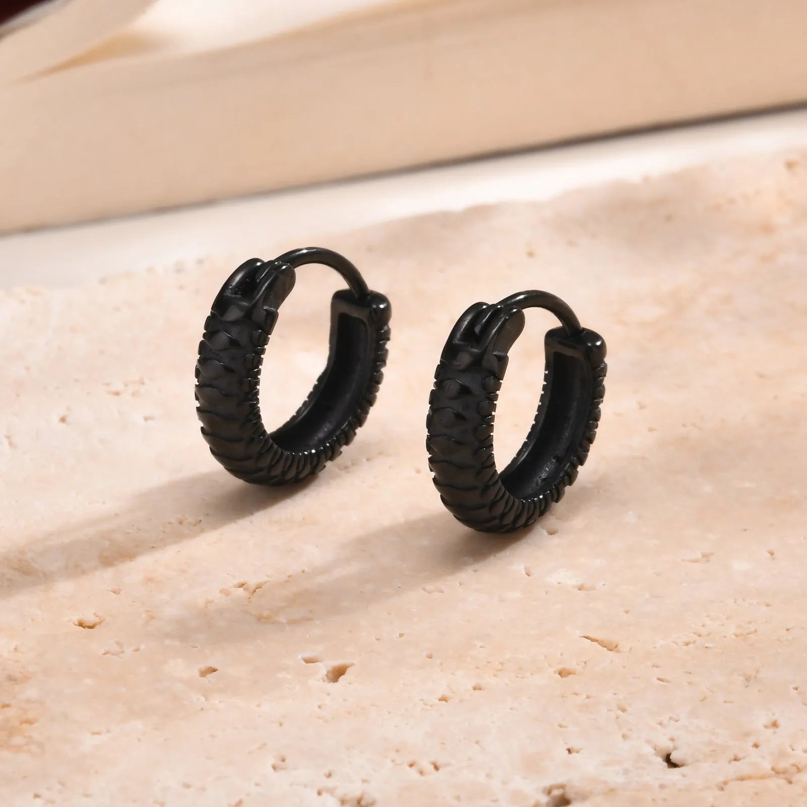 Stainless steel snake pattern earrings in black and gold finish, 30mm diameter