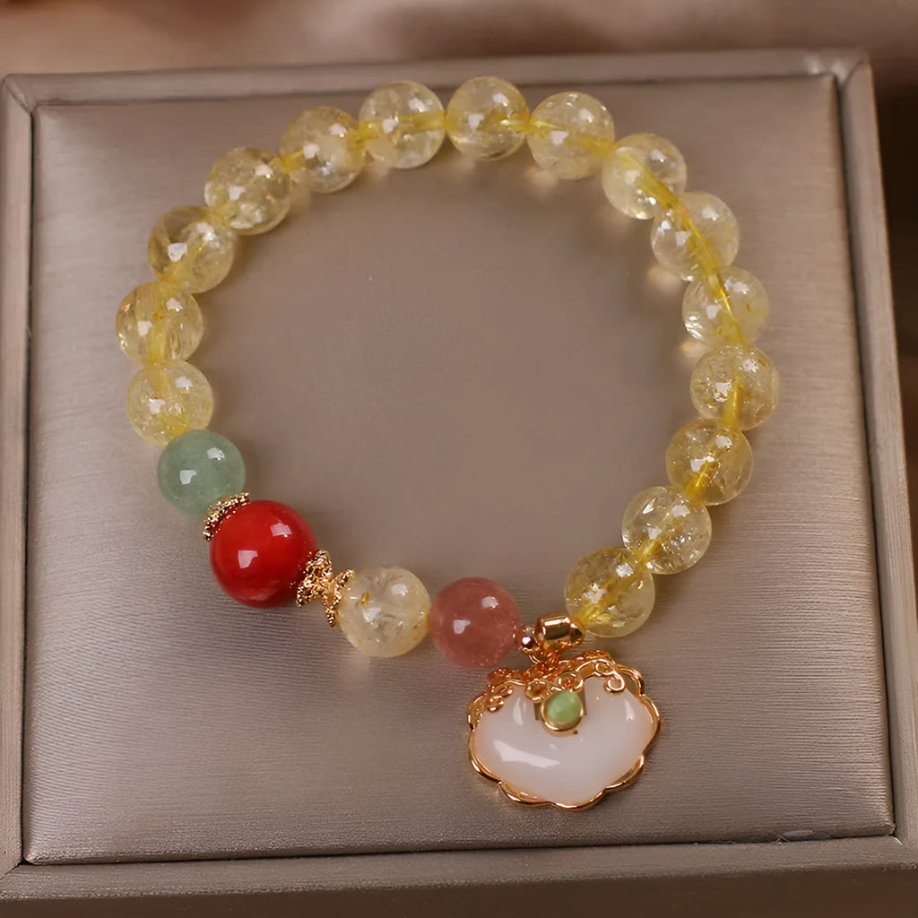 Women's yellow hair crystal jade ruyi pendant bracelet on an alloy chain.