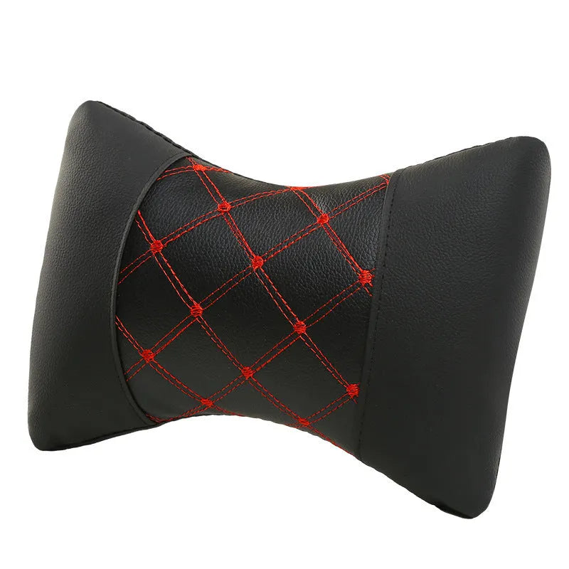 Quilted diamond pattern car neck pillow in black artificial leather with blue piping.