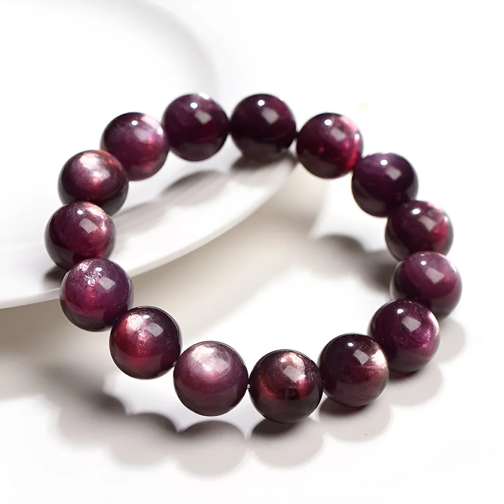 Natural purple lepidolite crystal round bead bracelet showing polished beads on a cord.