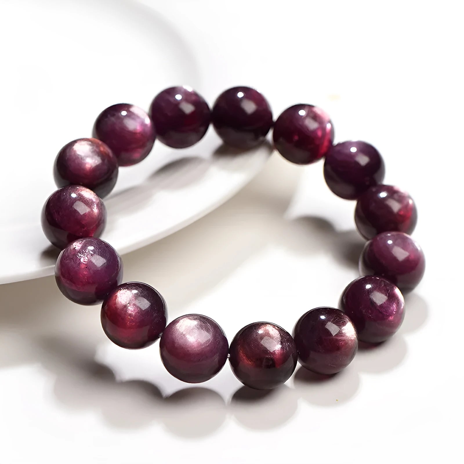 Natural purple lepidolite crystal round bead bracelet showing polished beads on a cord.