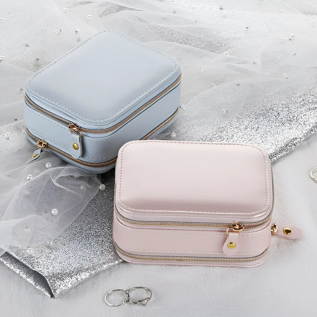 Small PU zipper jewellery box in light blue with fabric lining, 11.5x8.5x5cm, open to show rings and earrings