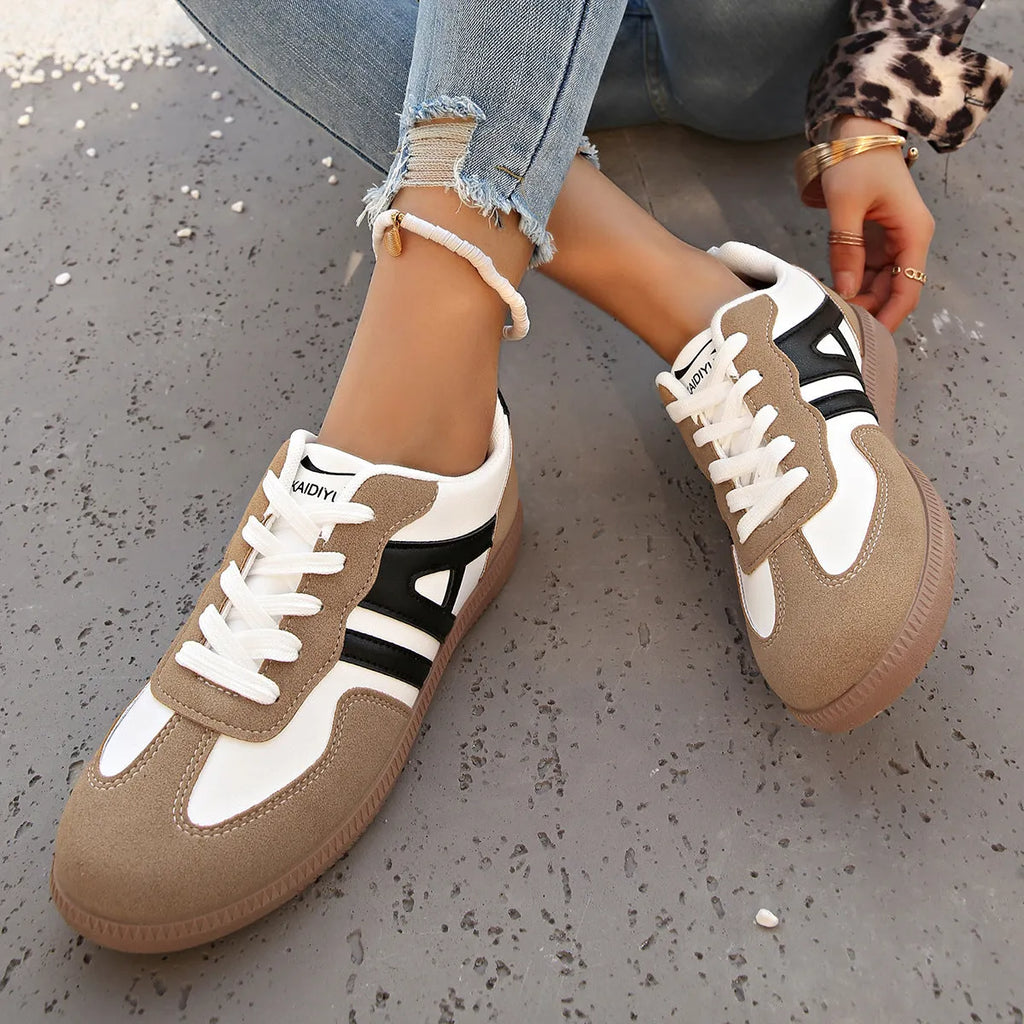 Women's retro lace-up jogging shoes in grey with a colour-matched cross strap and platform sole.