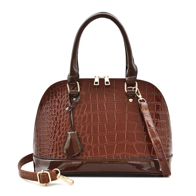 Large shiny black PU crossbody shoulder bag with shell suitcase shape on a white background.