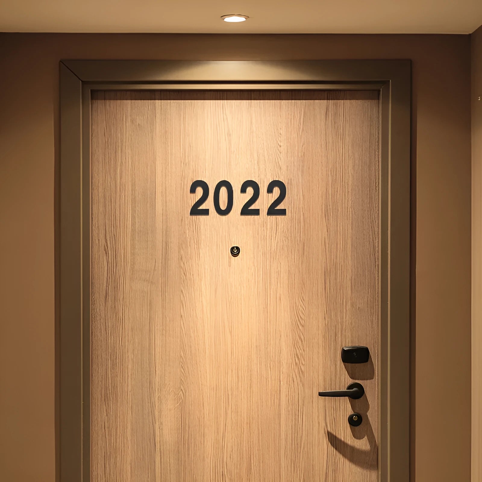 Black stainless steel adhesive house number plaque with a 7.5cm character size for outdoor use