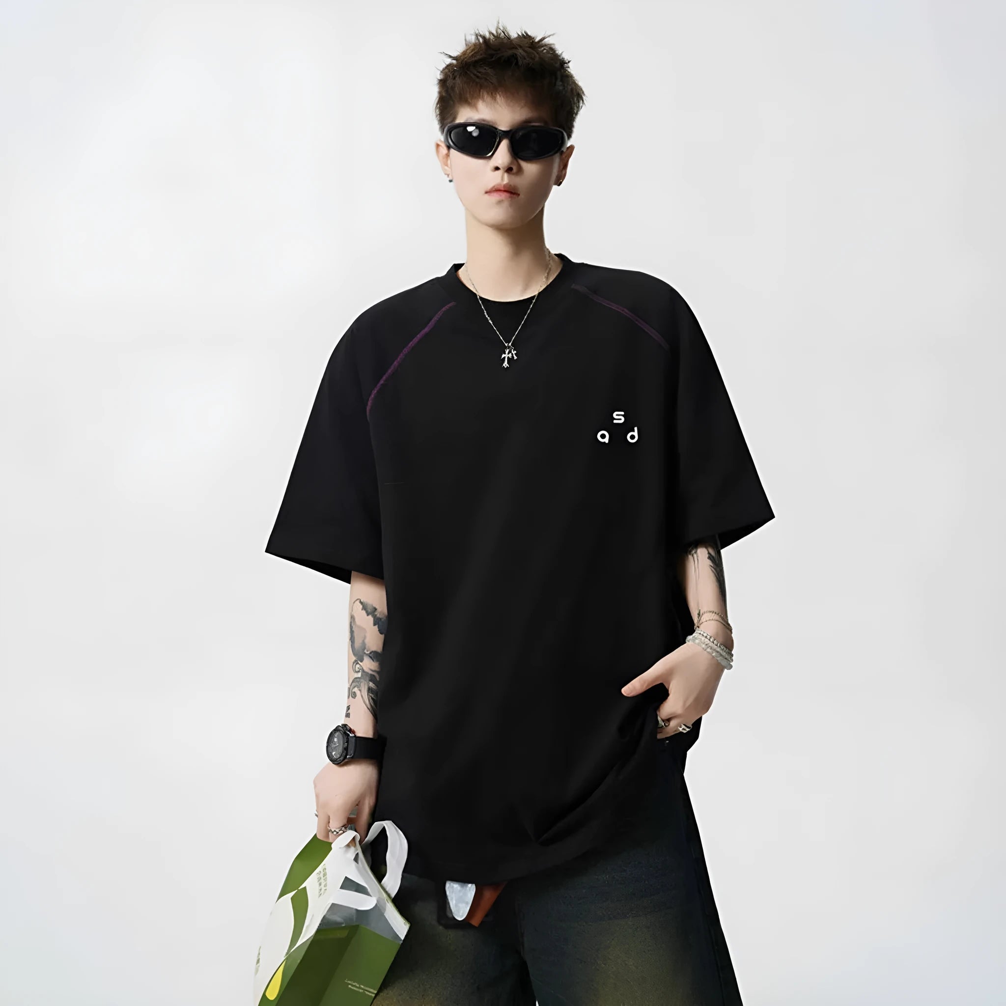 Man wearing a black loose-fit cotton short-sleeve T-shirt with a round neck collar.