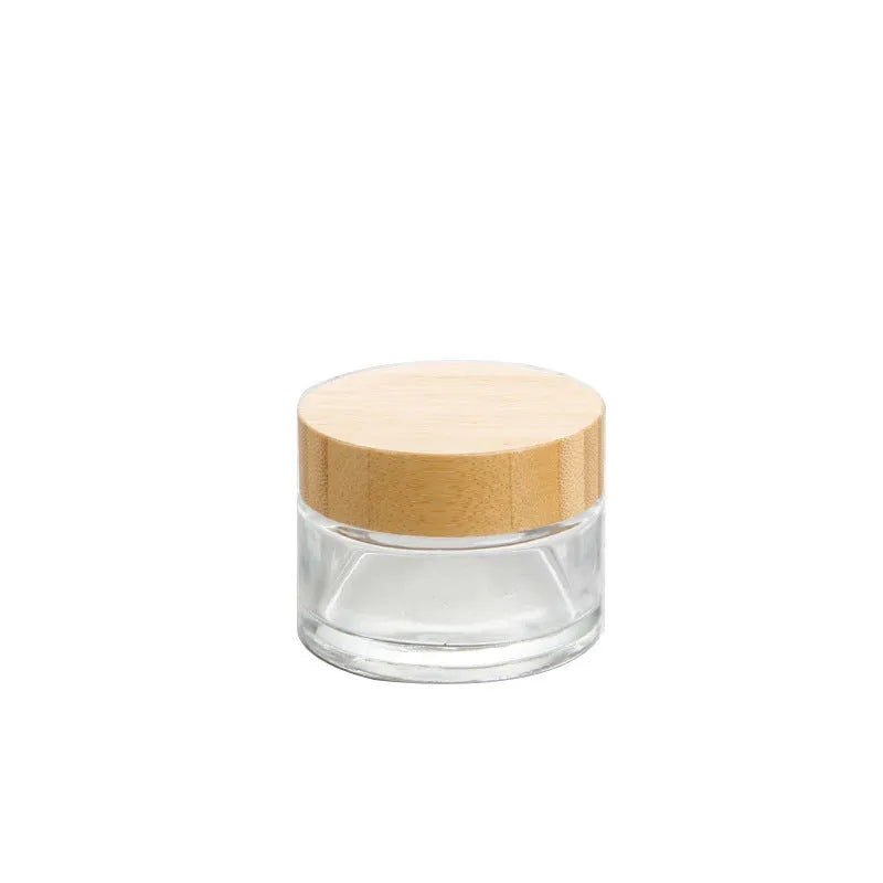 Glass sub-bottle with bamboo wood cover for travel cream in 50g size, transparent finish