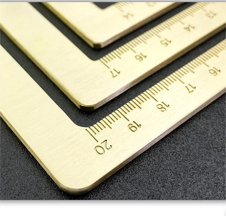 Solid brass square calligraphy paper weight with hand engraved surface on desk