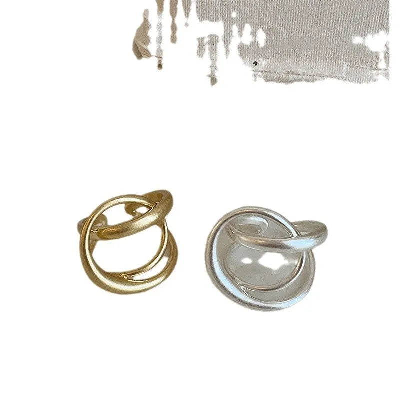 Geometric open ring with three-dimensional interlaced design in matte metal