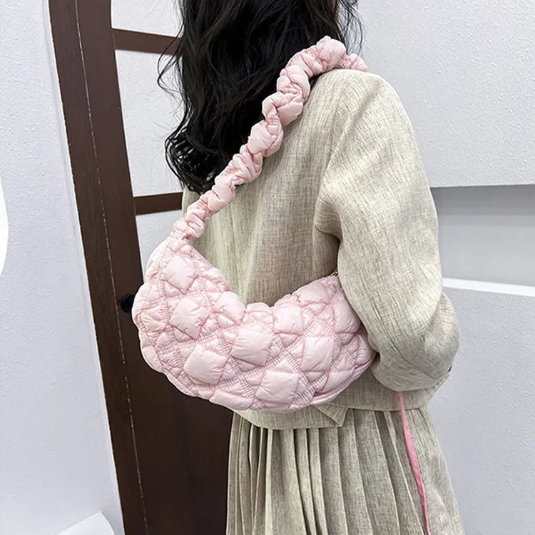 Women's light beige nylon underarm messenger bag with a long shoulder strap.