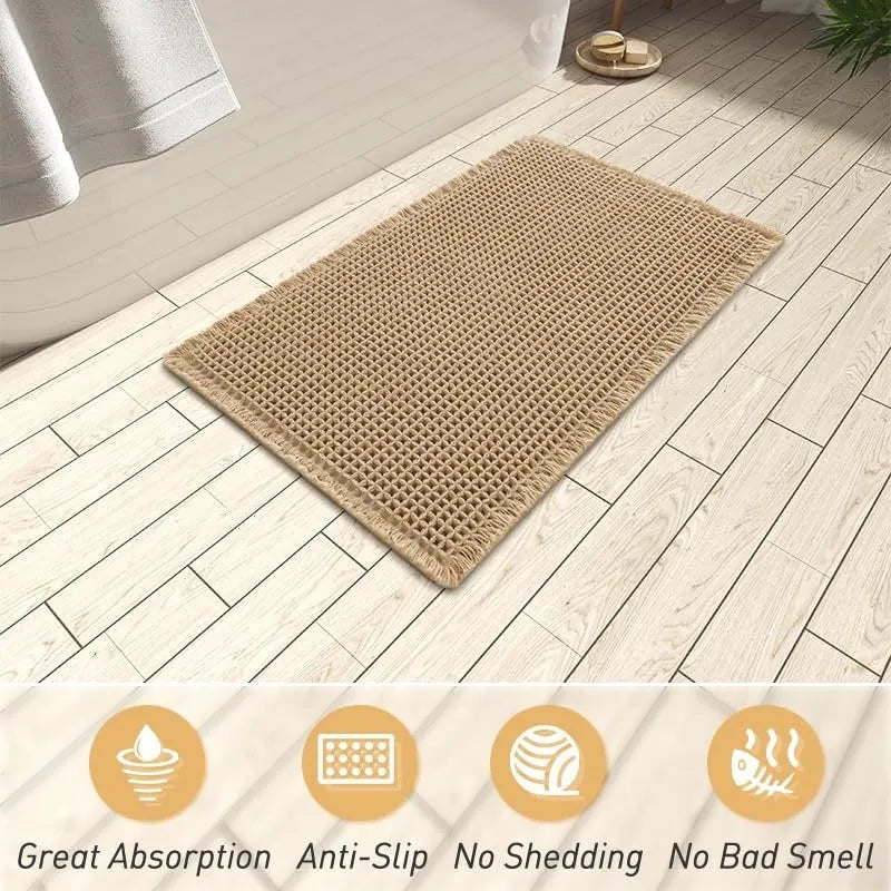 Square checkered pattern bathroom mat on tiled floor in a neutral beige colour.