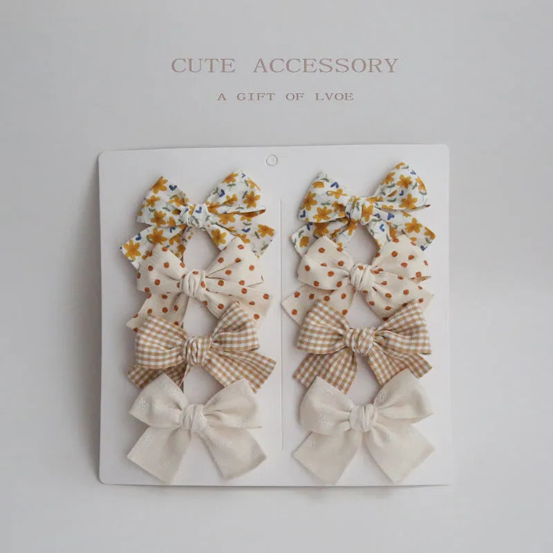 Children's cloth hairclips with dovetail bow design in beige brown grid dots pattern