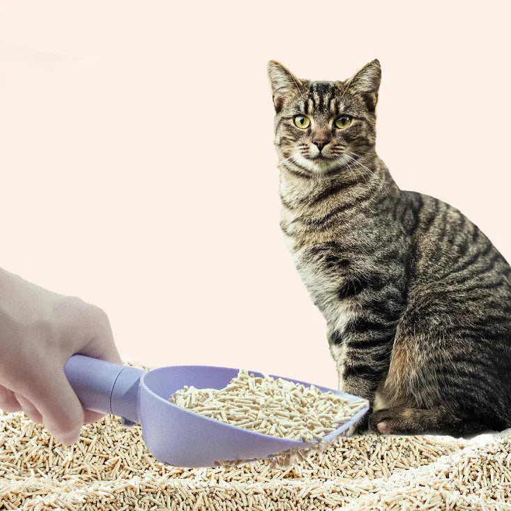 Plastic cat litter scoop with base in white model, showing hidden bag storage compartment and large scoop head with alternating apertures