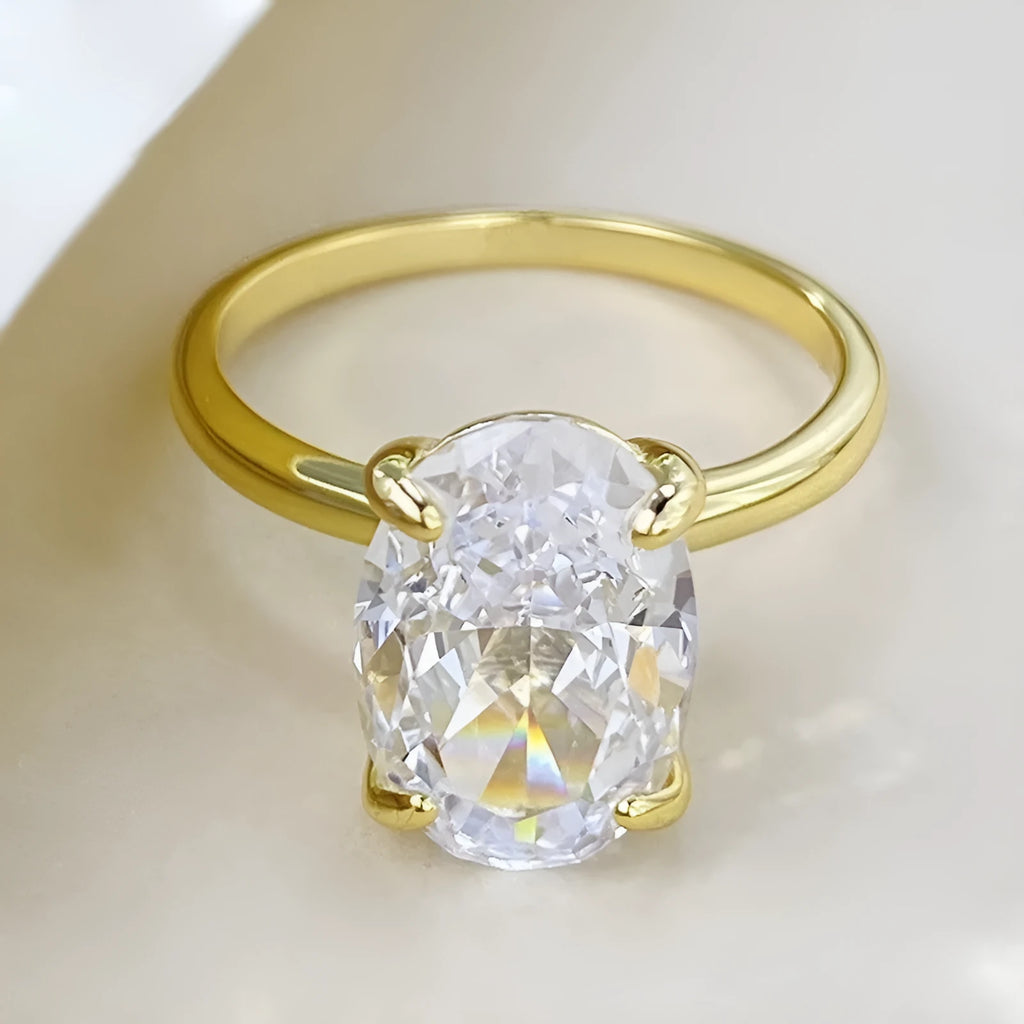 Oval solitaire ring in sterling silver with a four-prong setting and a central gemstone.