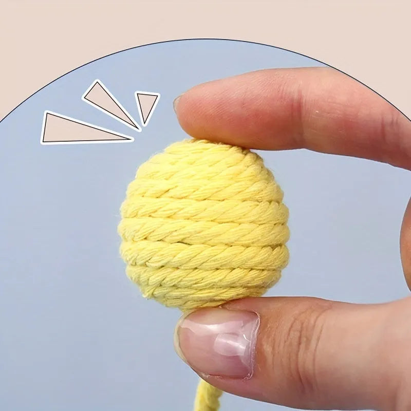 Colourful cat toy ball with attached rope and built-in bell in green, pink, purple, and yellow
