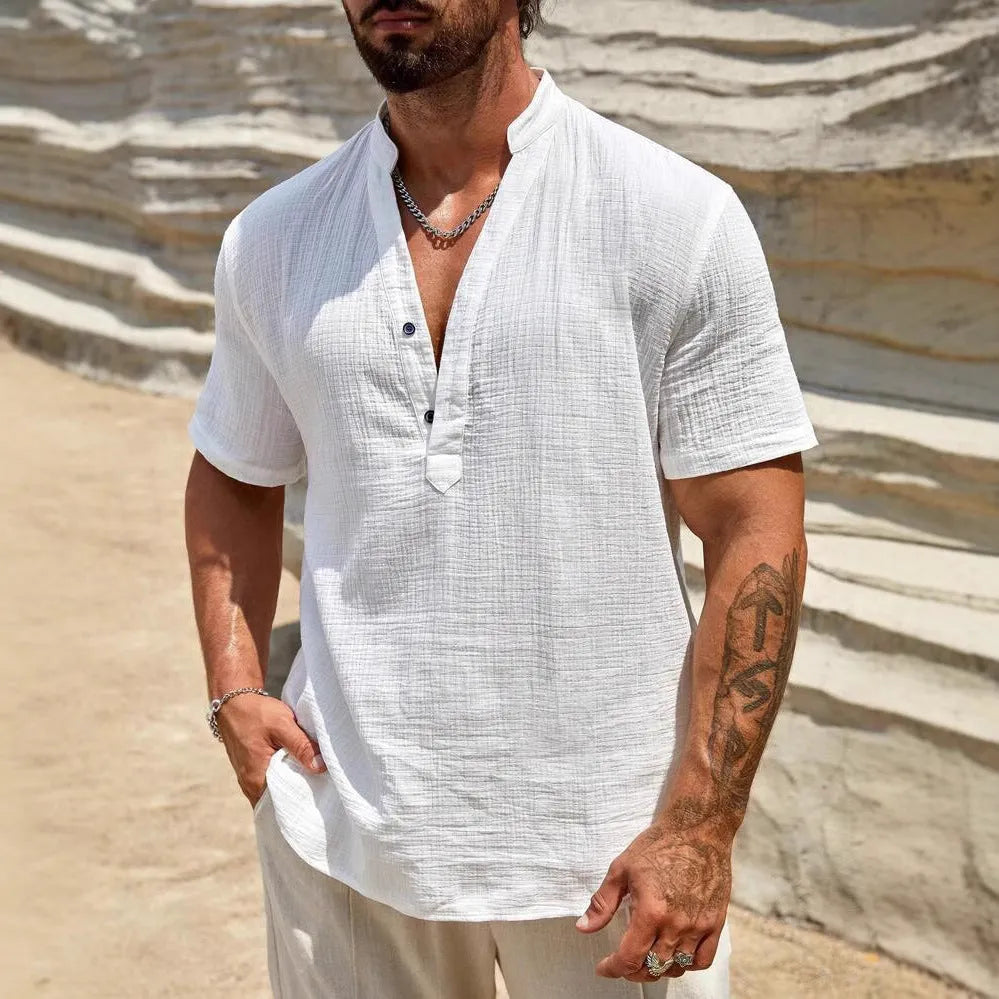 Men's solid colour short-sleeved shirt with stand collar in light blue, laid flat.