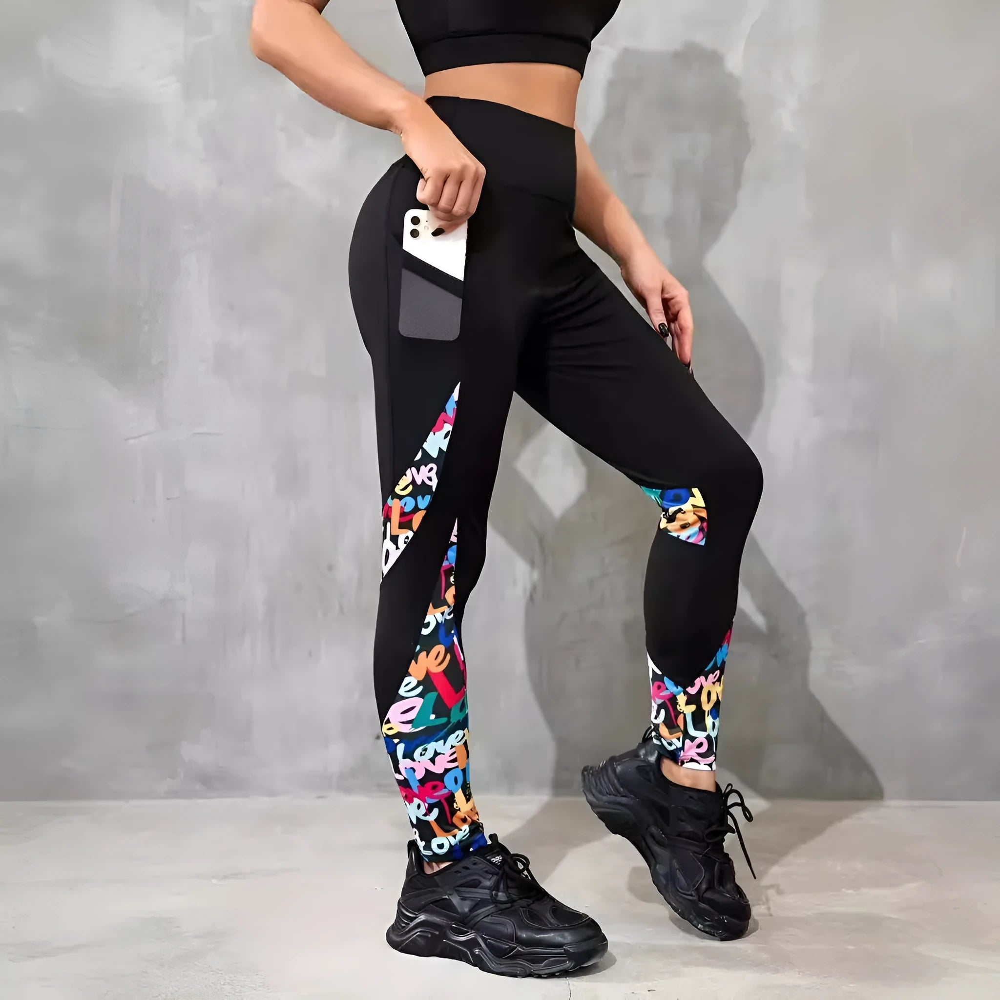 Woman wearing black ribbon letters colour contrast patchwork high waist yoga leggings with pocket