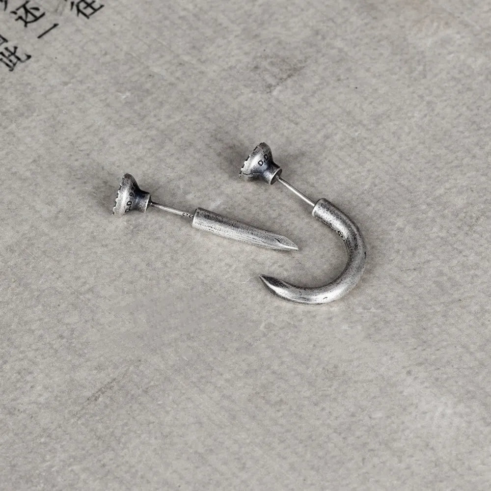 S925 sterling silver punk stud earring in straight nail or curved nail design on a hook.