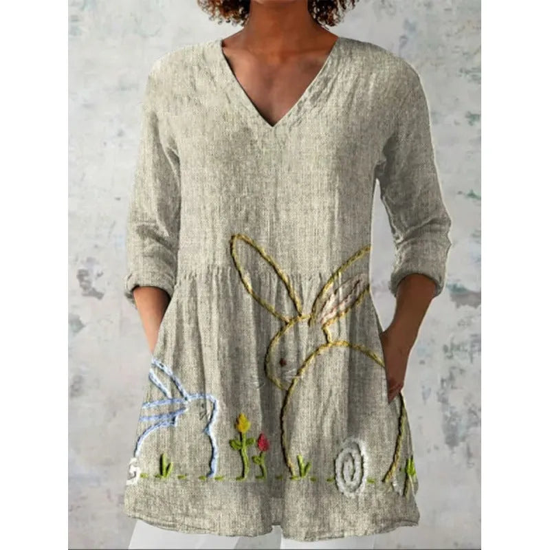 Women's printed loose dress with wide waist and 3/4 length sleeves on a hanger.