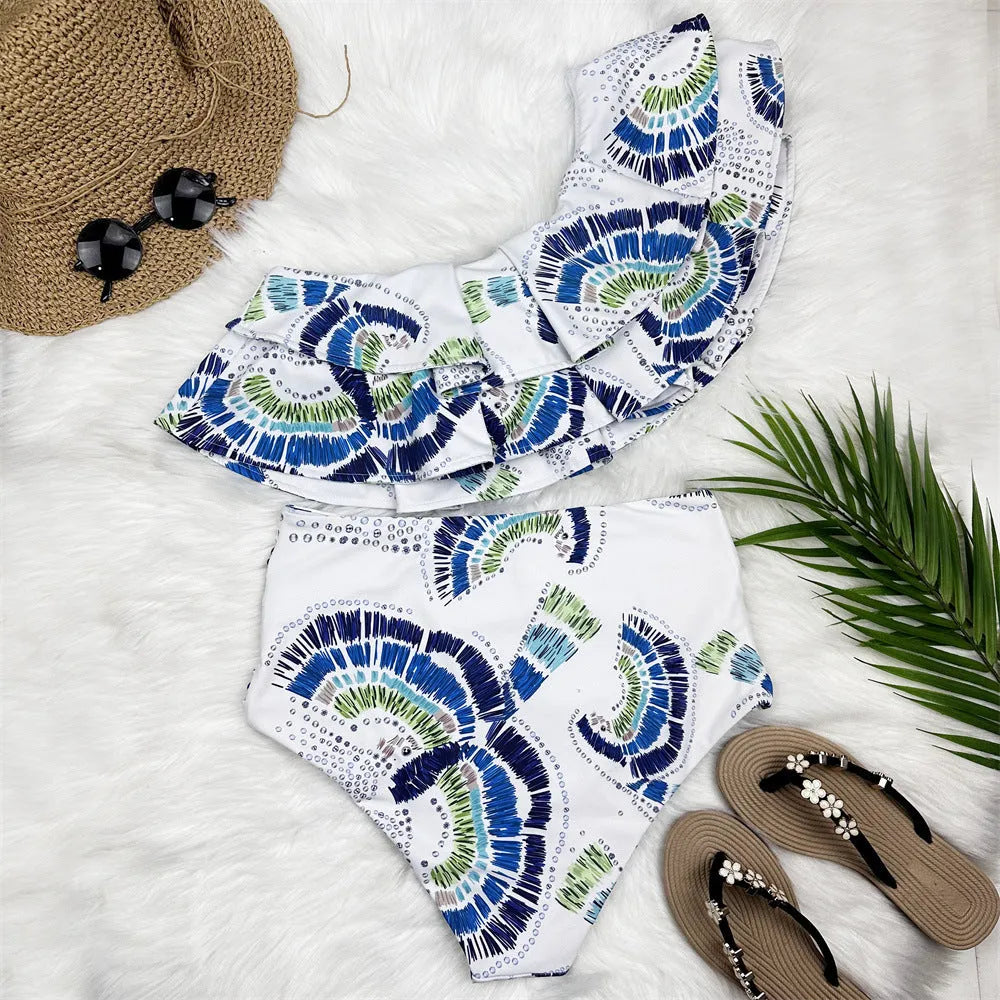 White women's one-shoulder swimsuit with large lotus leaf design and split bikini bottom