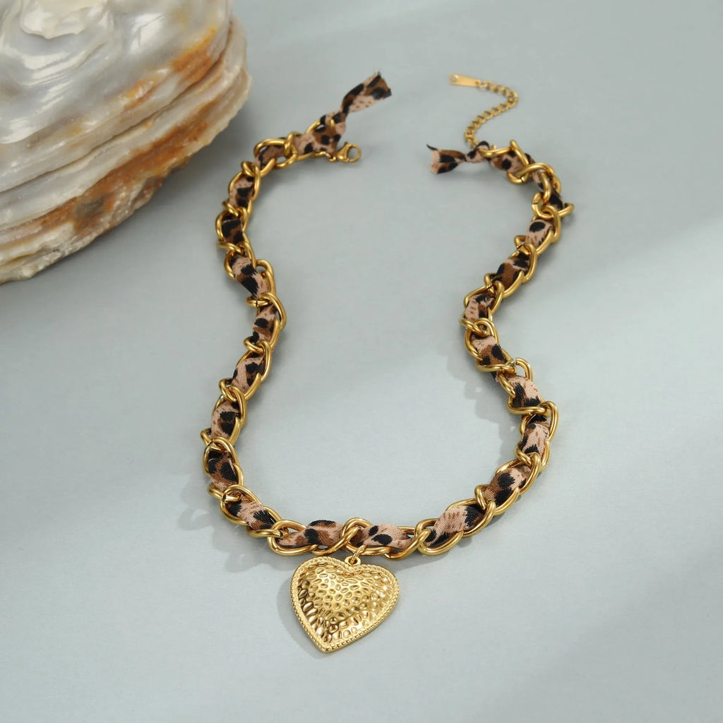 Geometric leopard love pendant on adjustable stainless steel necklace chain with gold-toned finish