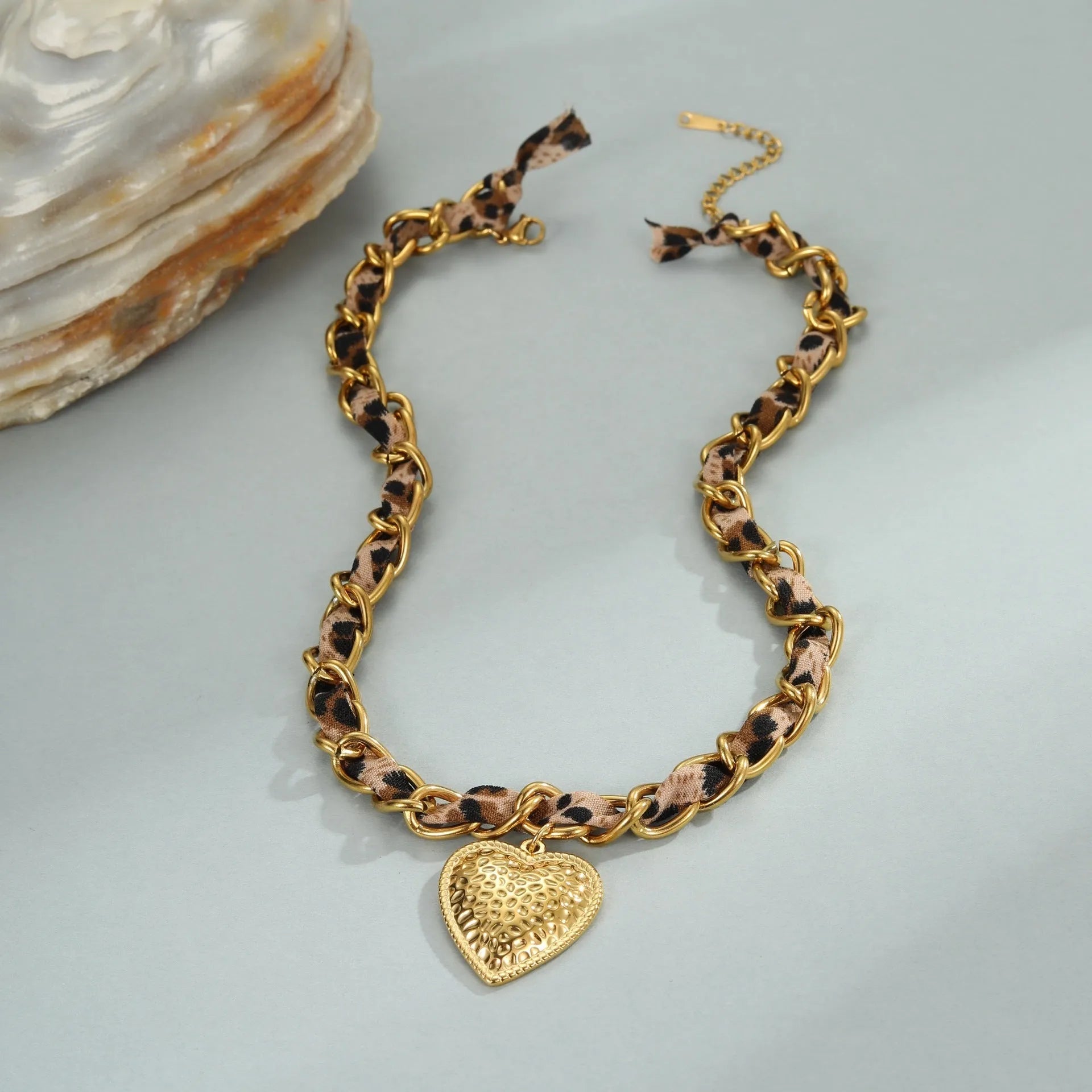Geometric leopard love pendant on adjustable stainless steel necklace chain with gold-toned finish