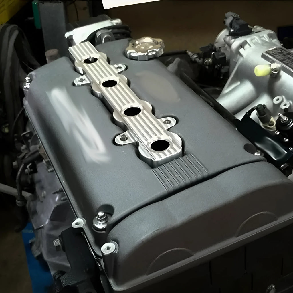 Aluminium alloy engine harness mounting bracket in blue, red, or silver finish, shown with and without pre-drilled holes.