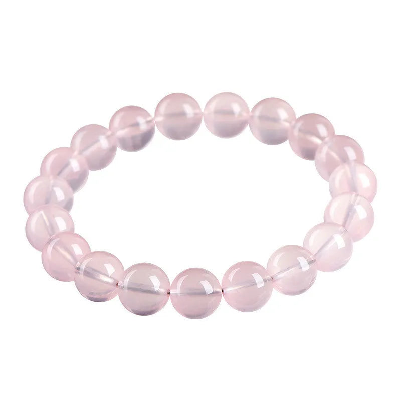 Natural starlight crystal round bead bracelet in pink with polished finish showing bead detail