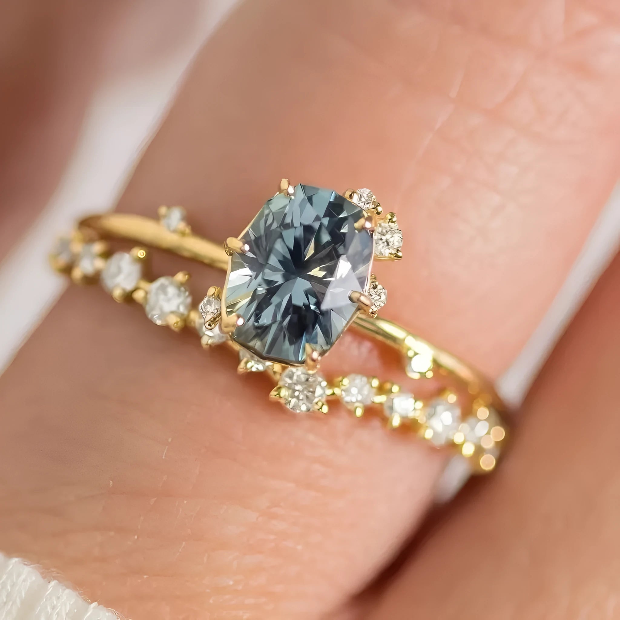 Gold-plated flower-shaped ring with green zircon stones on a model finger