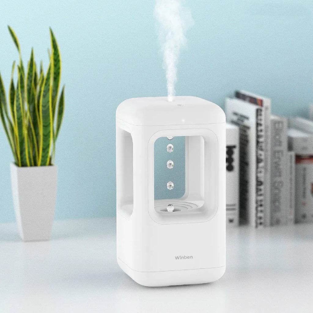 White anti-gravity water drop humidifier with ambient light on bedside table
