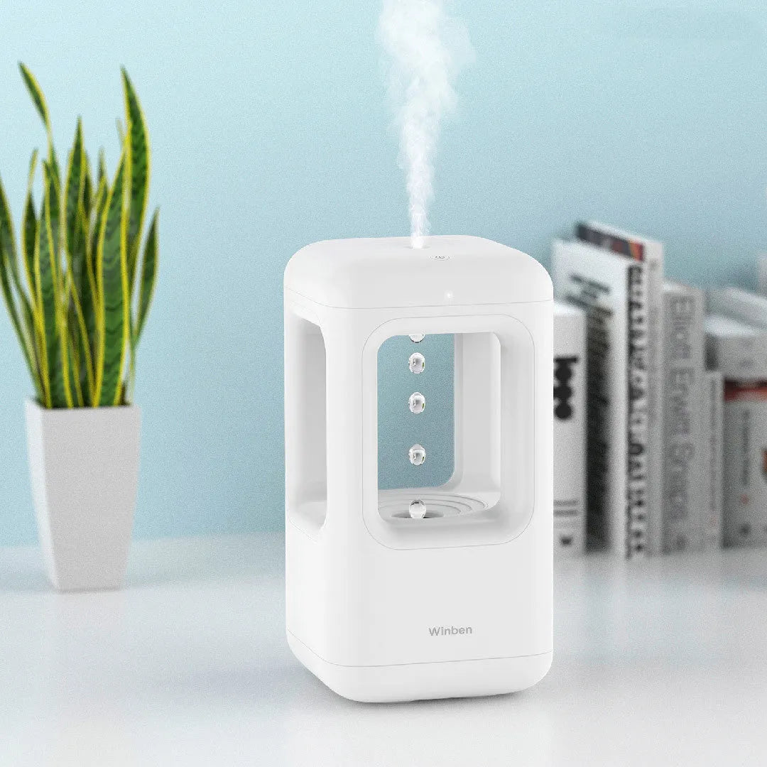White anti-gravity water drop humidifier with ambient light on bedside table